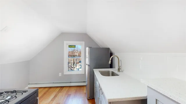 a kitchen with a stove and white cabinets