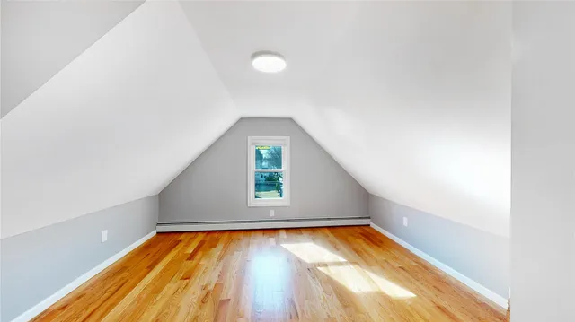 a kitchen with a sink a stove and wooden floor
