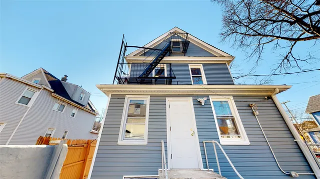 a view of a patio with table and chairs with wooden floor and fence