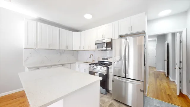 a room with a bed and wooden floor