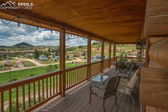 a view of a chairs and table in the balcony