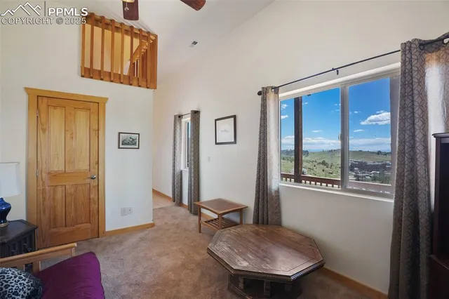 a view of a bedroom with a bed and wooden floor