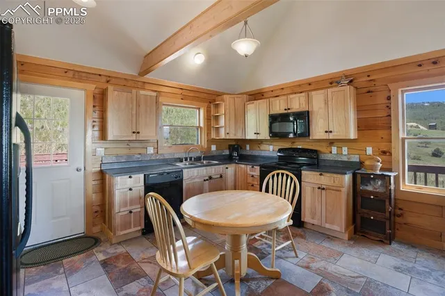 a kitchen with stainless steel appliances granite countertop a stove a sink a microwave and a refrigerator