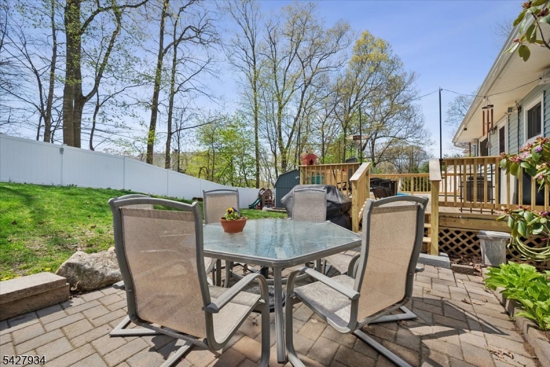 77 Brooklyn Road Stanhope, NJ 07874 - Photo 16 of 21 a backyard of a house with table and chairs