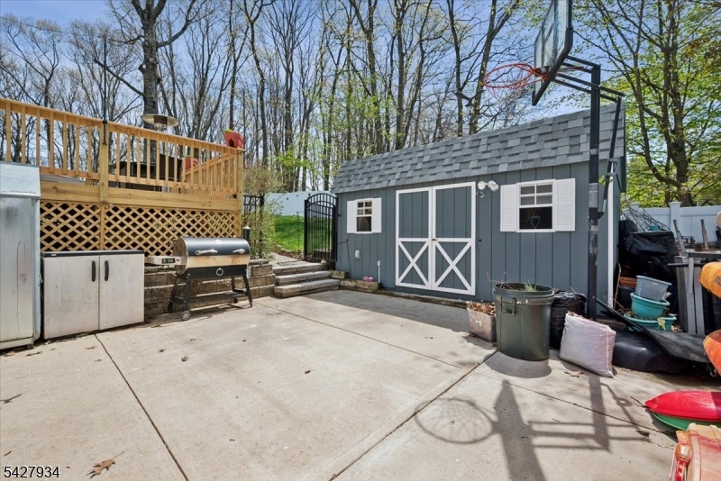 77 Brooklyn Road Stanhope, NJ 07874 - Photo 19 of 21 a view of a patio with table and chairs with wooden fence and plants