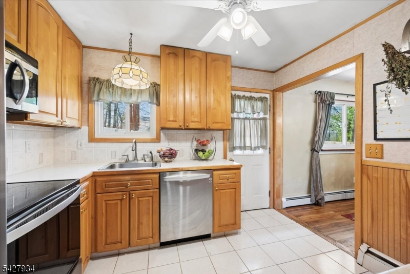 77 Brooklyn Road Stanhope, NJ 07874 - Photo 2 of 21 a kitchen with a sink dishwasher a stove and a refrigerator with wooden floor