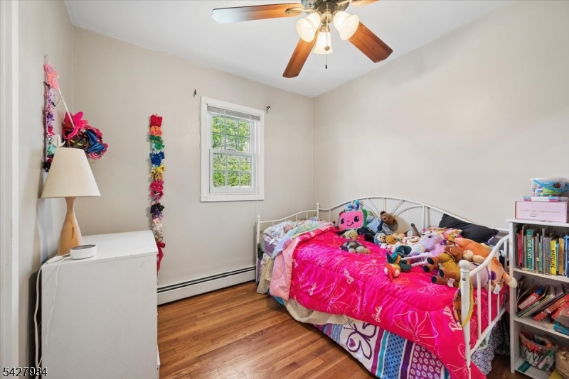 77 Brooklyn Road Stanhope, NJ 07874 - Photo 8 of 21 a bedroom with a bed and a chandelier