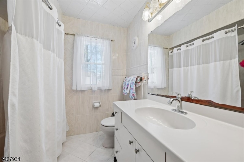 77 Brooklyn Road Stanhope, NJ 07874 - Photo 9 of 21 a bathroom with a sink toilet and shower