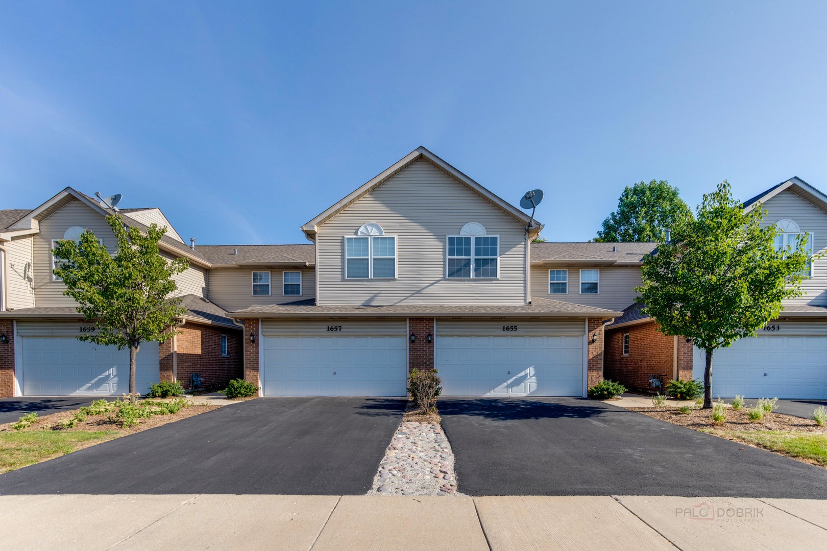 1655 Windward Court Naperville, IL 60563 - Photo 2 of 34 a front view of a house with a yard and garage