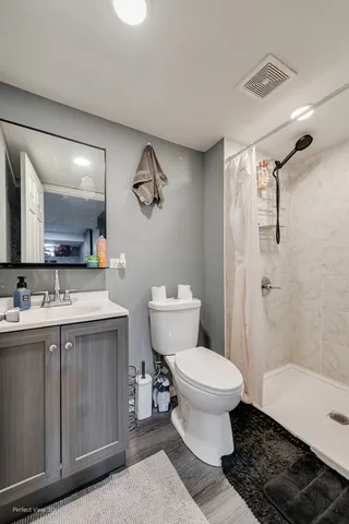 a bathroom with a sink toilet and shower