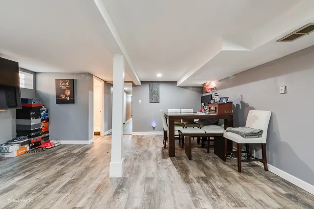 a view of a workspace with furniture and a wooden floor