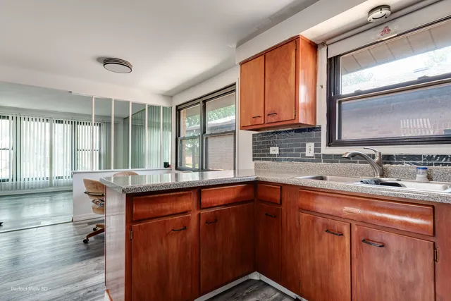 a kitchen with granite countertop cabinets sink and window