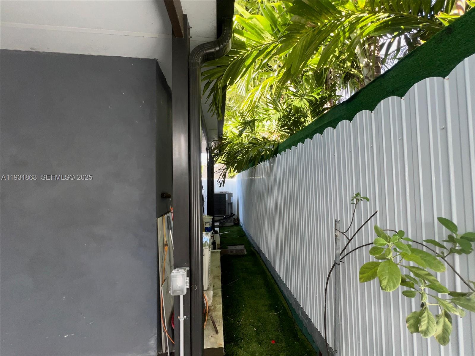 3297-3299 Southwest 26th Street Miami, FL 33133 - Photo 38 of 45 a view of a flower pot with wooden fence