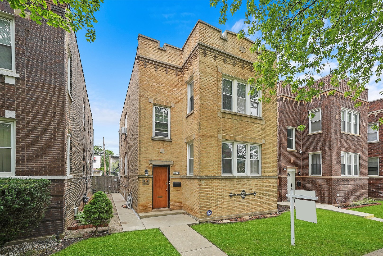 1738 North Menard Avenue Chicago, IL 60639 - Photo 2 of 9 a view of a large building with a yard