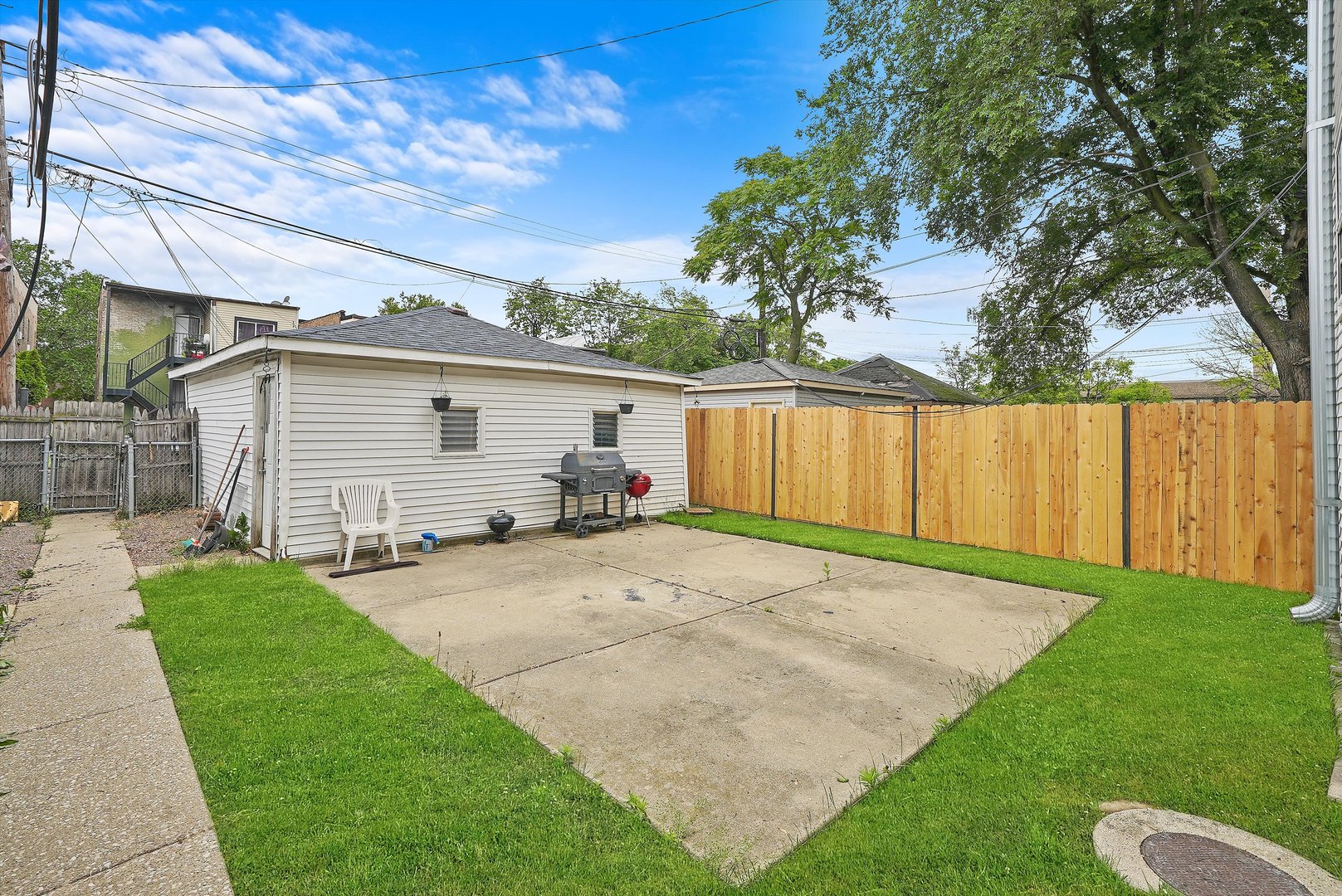 1738 North Menard Avenue Chicago, IL 60639 - Photo 4 of 9 a view of a backyard with table and chairs and a large tree