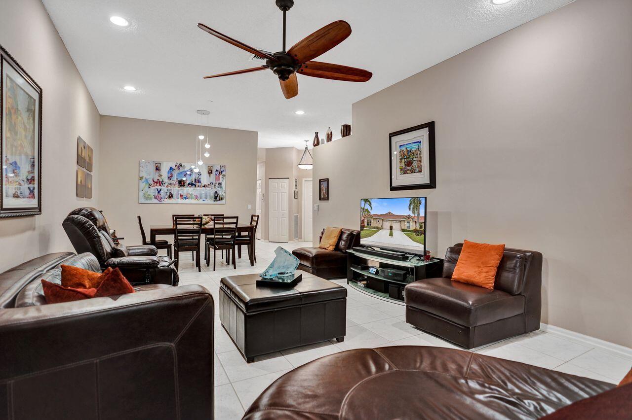6251 Long Key Lane Boynton Beach, FL 33472 - Photo 11 of 41 a living room with furniture a rug and a ceiling fan
