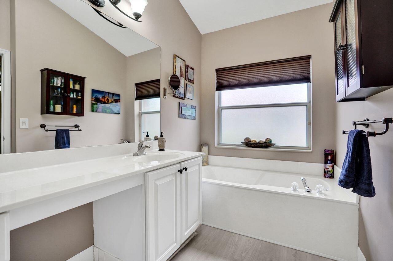 6251 Long Key Lane Boynton Beach, FL 33472 - Photo 16 of 41 a bathroom with a tub sink and mirror