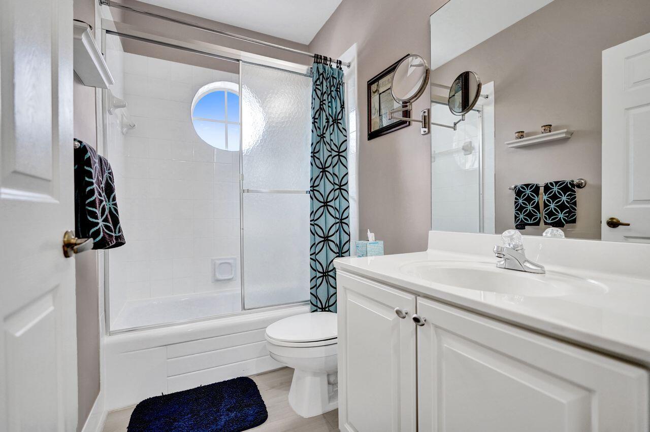 6251 Long Key Lane Boynton Beach, FL 33472 - Photo 20 of 41 a bathroom with a sink a toilet and shower
