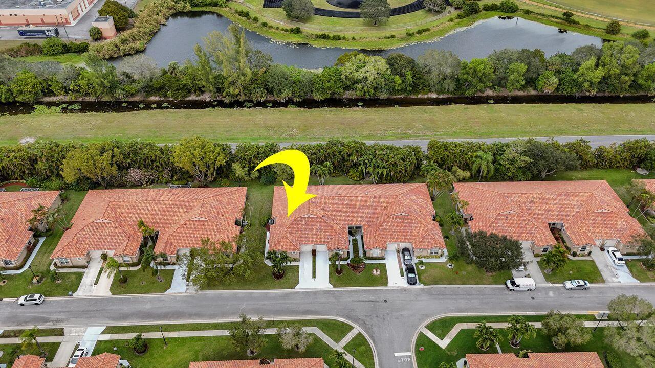 6251 Long Key Lane Boynton Beach, FL 33472 - Photo 2 of 41 a aerial view of a house with a garden and lake view