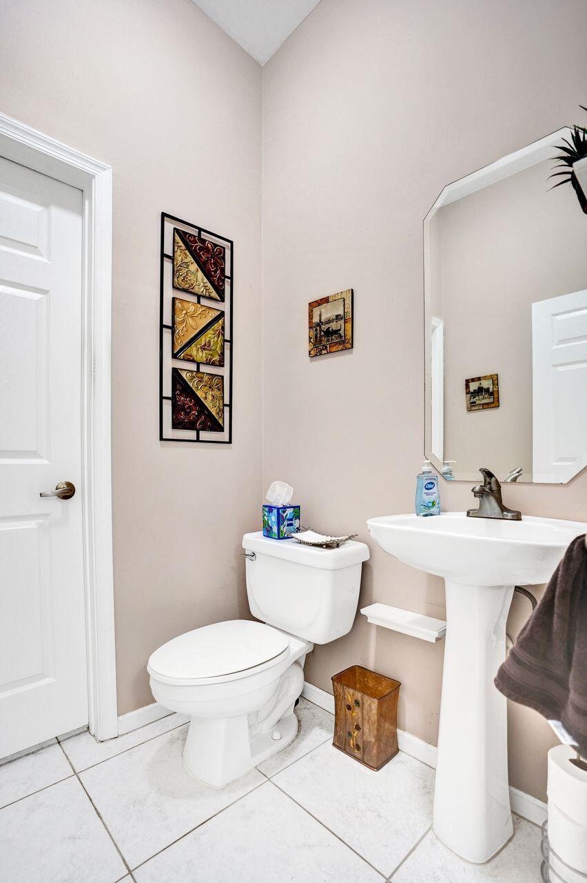 6251 Long Key Lane Boynton Beach, FL 33472 - Photo 25 of 41 a bathroom with a sink toilet and a mirror