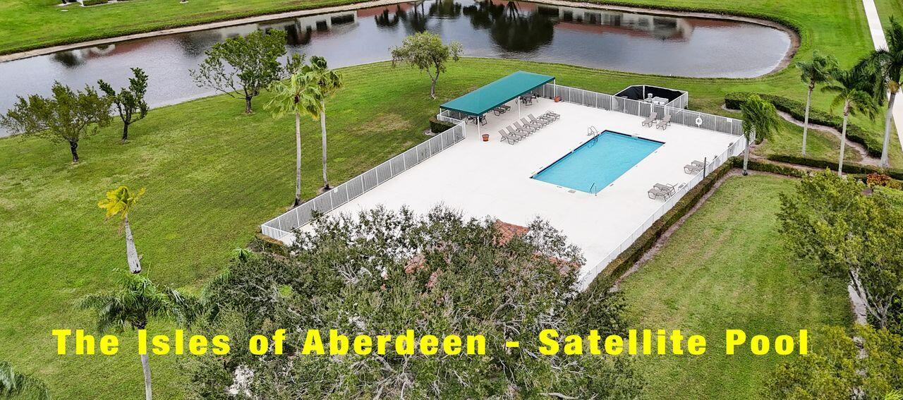 6251 Long Key Lane Boynton Beach, FL 33472 - Photo 27 of 41 a view of a swimming pool with a yard