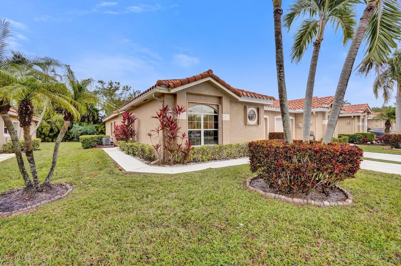 6251 Long Key Lane Boynton Beach, FL 33472 - Photo 3 of 41 a front view of a house with garden
