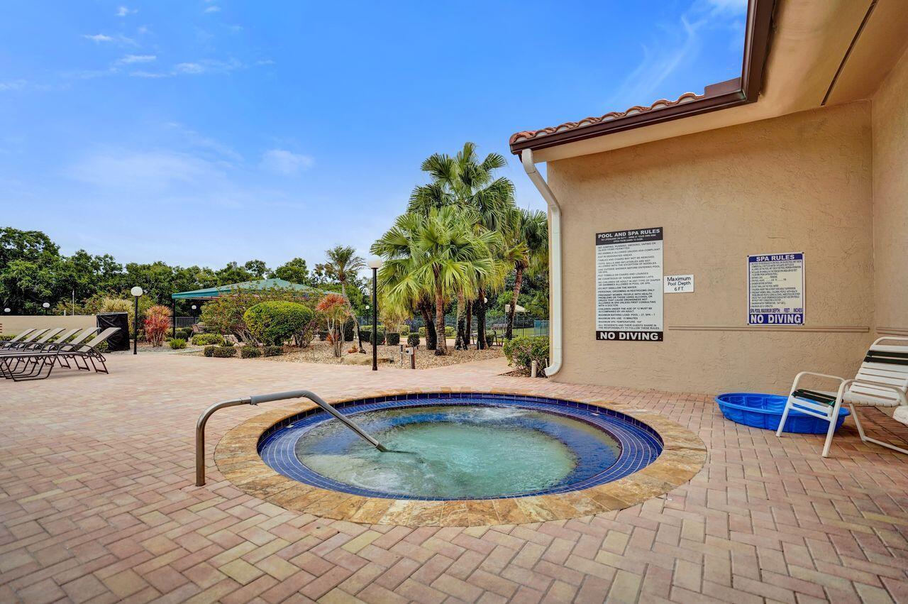 6251 Long Key Lane Boynton Beach, FL 33472 - Photo 33 of 41 a swimming pool with outdoor seating and yard in back