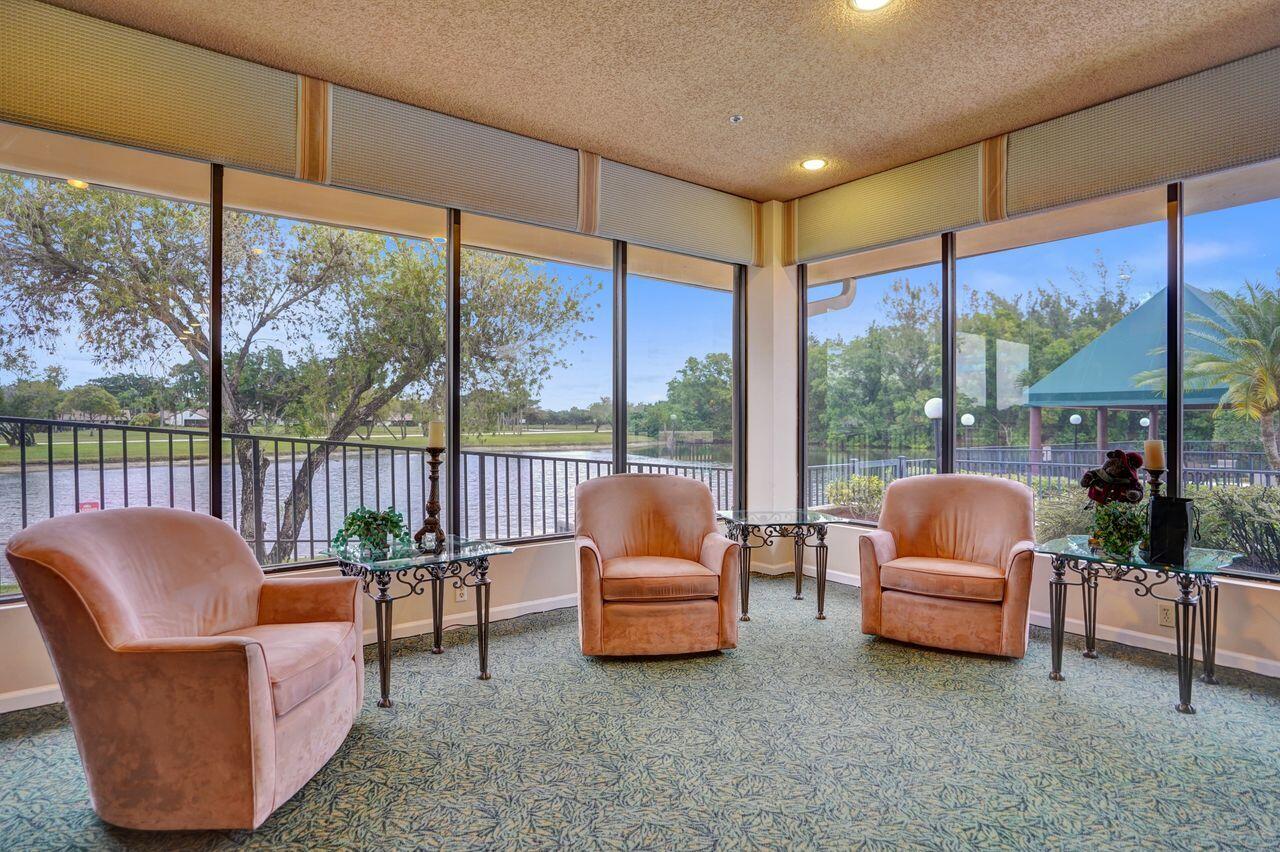 6251 Long Key Lane Boynton Beach, FL 33472 - Photo 37 of 41 a living room with furniture and a floor to ceiling window