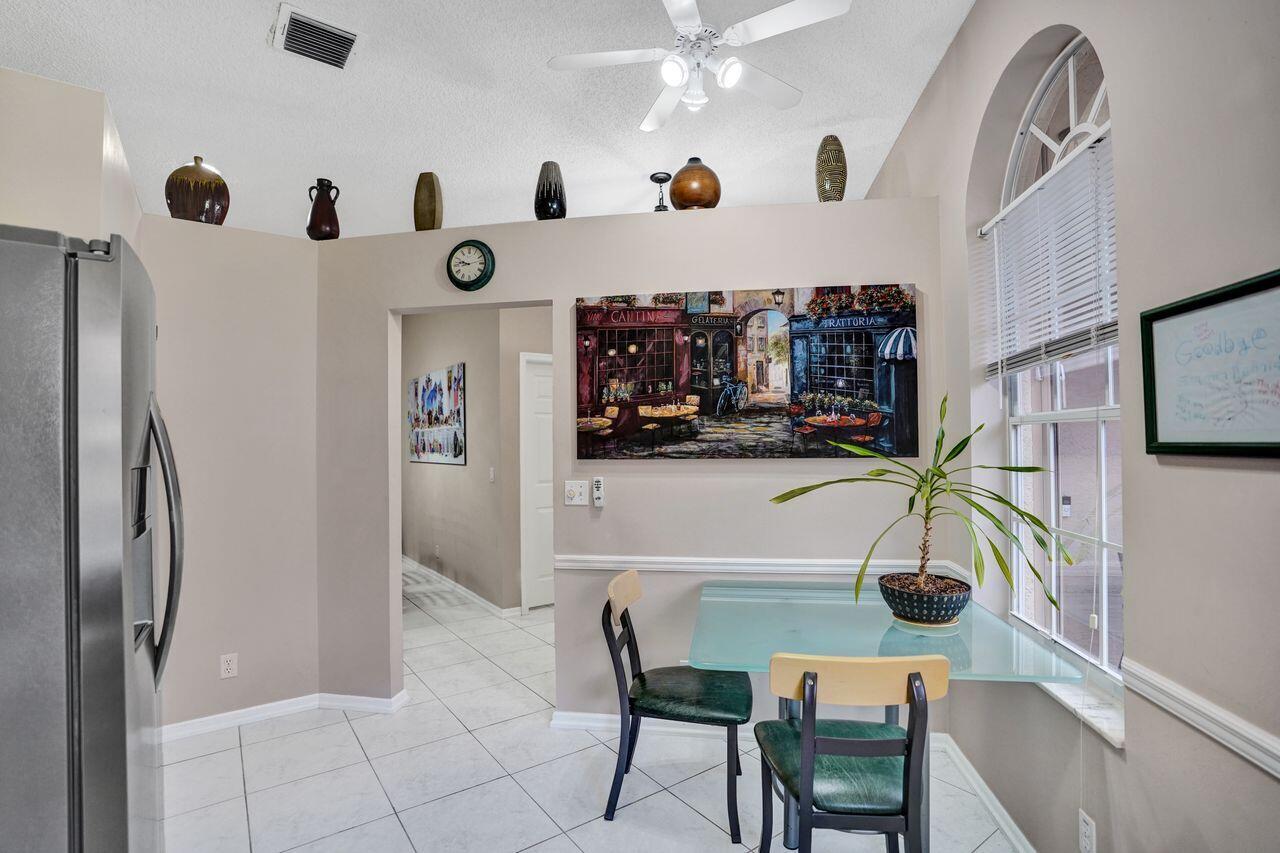 6251 Long Key Lane Boynton Beach, FL 33472 - Photo 7 of 41 a view of kitchen and dining area with chandelier
