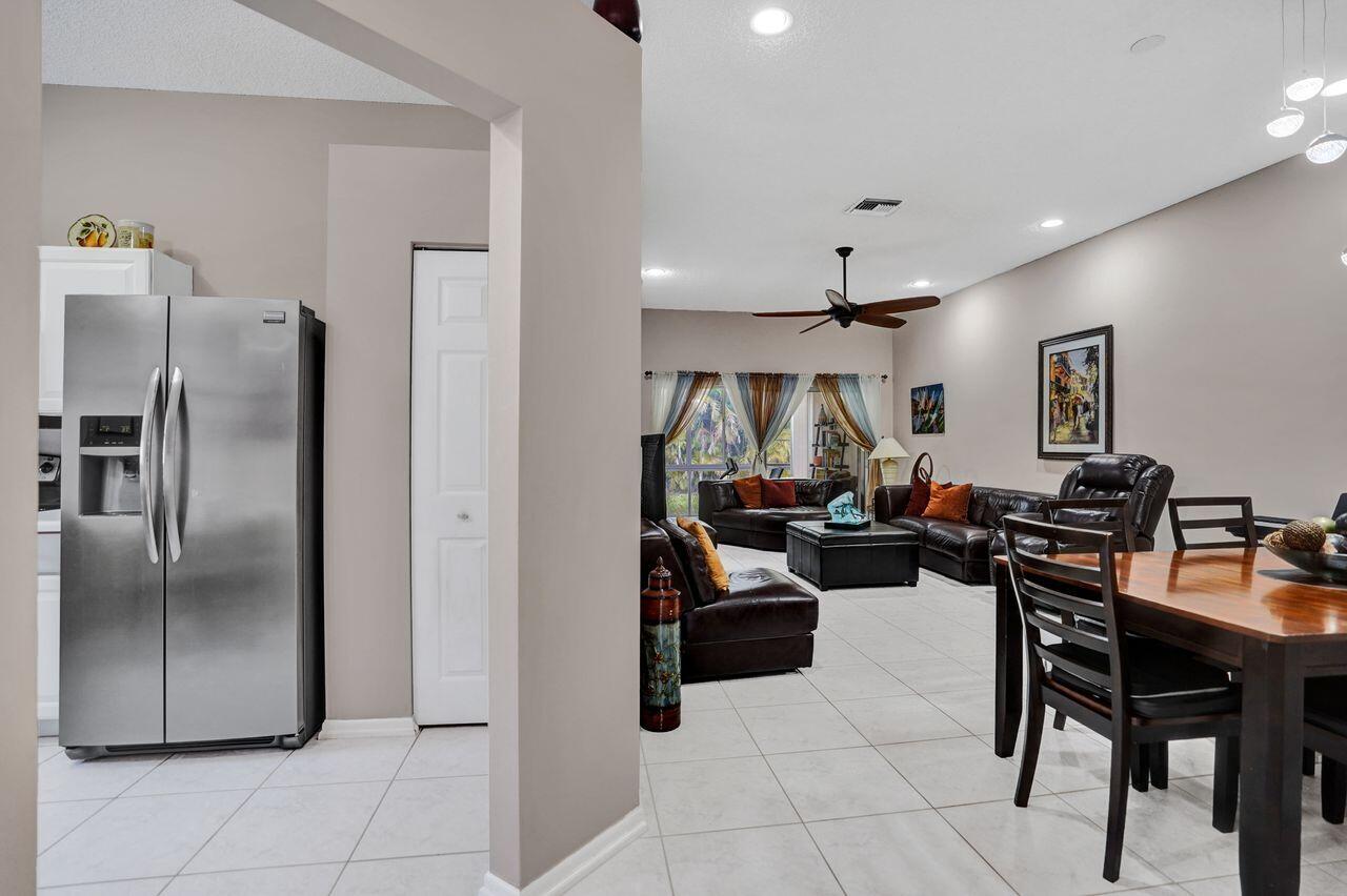 6251 Long Key Lane Boynton Beach, FL 33472 - Photo 8 of 41 a living room with furniture a refrigerator and a table