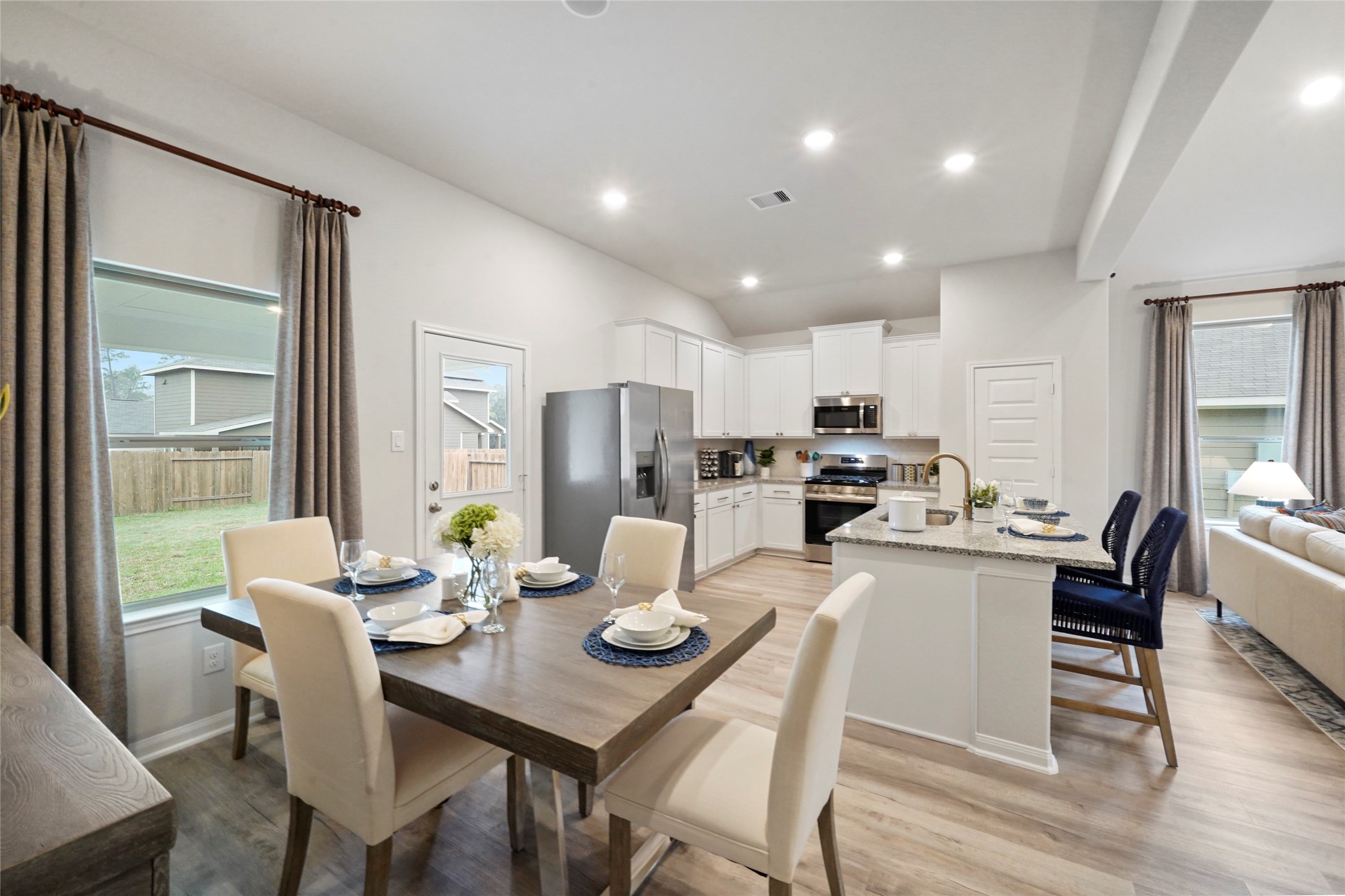 604 Danielle Dayton, TX 77535 - Photo 11 of 34 a kitchen with a dining table chairs and refrigerator