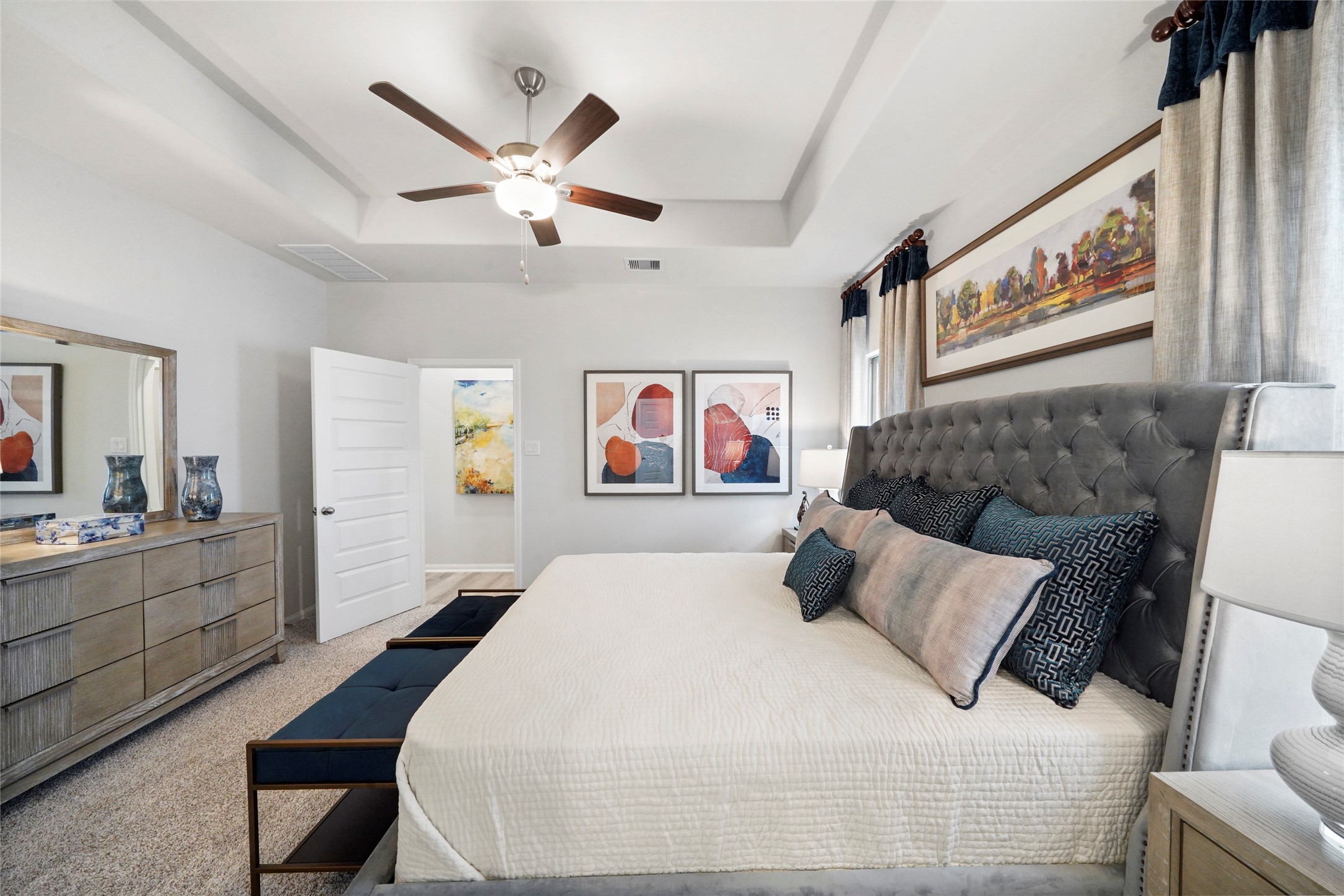 604 Danielle Dayton, TX 77535 - Photo 23 of 34 a bedroom with a large bed and a chandelier