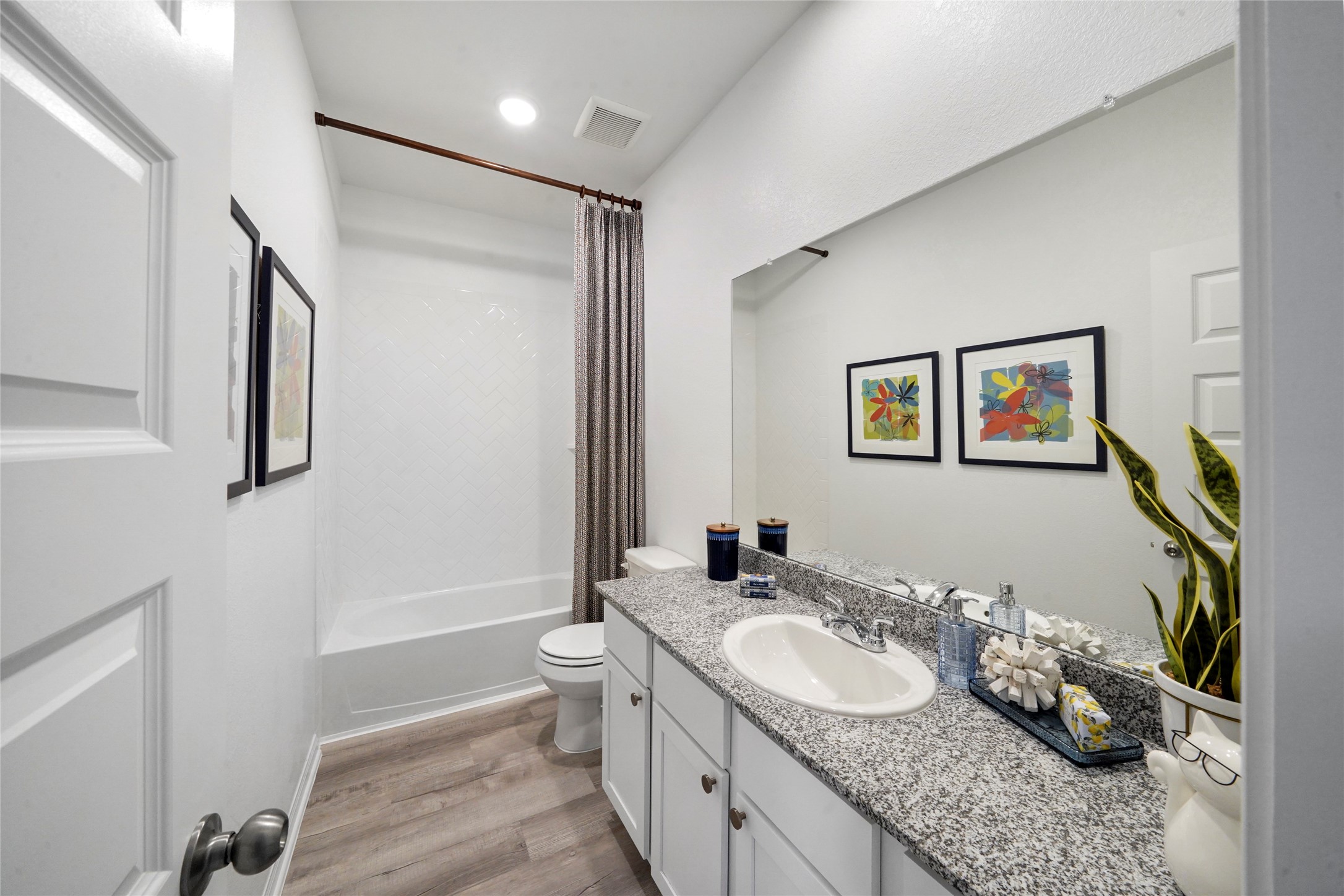 604 Danielle Dayton, TX 77535 - Photo 24 of 34 a bathroom with a granite countertop sink mirror vanity and toilet
