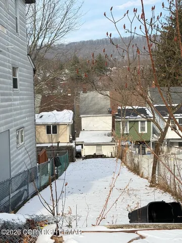 a view of a patio with a table and chairs under an umbrella