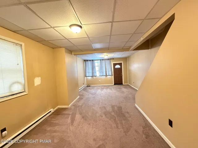 a view of a dining room with furniture and window