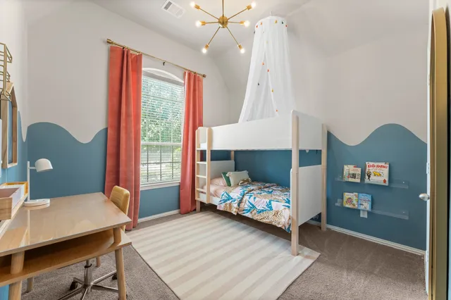 a bedroom with a bed and a table