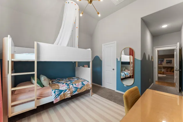 a bedroom with bed and wooden floor