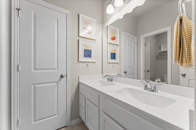 a bathroom with a double vanity sink and a mirror
