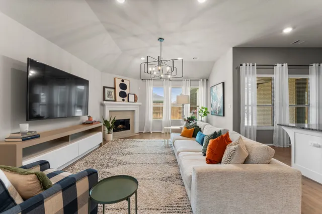 a living room with fireplace furniture and a flat screen tv