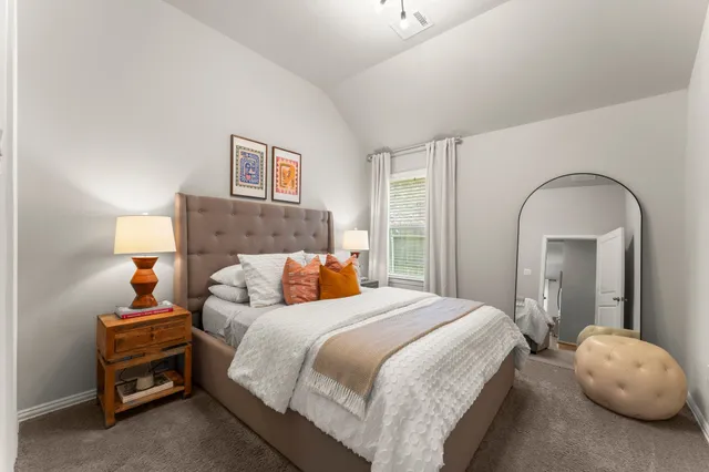 a bedroom with a bed and a mirror