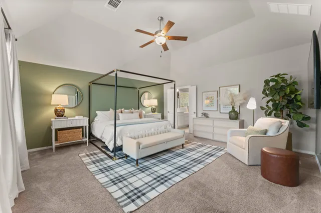 a bedroom with a bed a couch and a chandelier