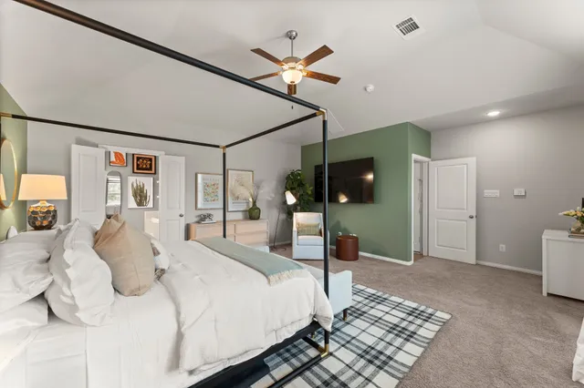 a bed room with a bed and a ceiling fan