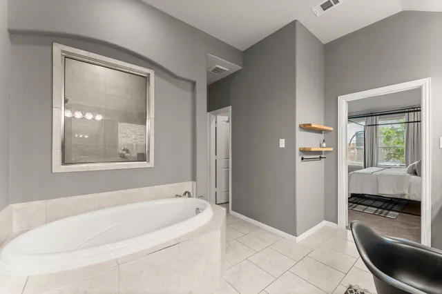 a bathroom with a tub toilet and window