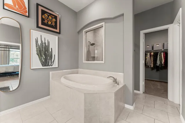 a bathroom with a bathtub and a window