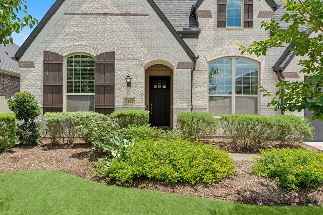front view of a house with potted plants
