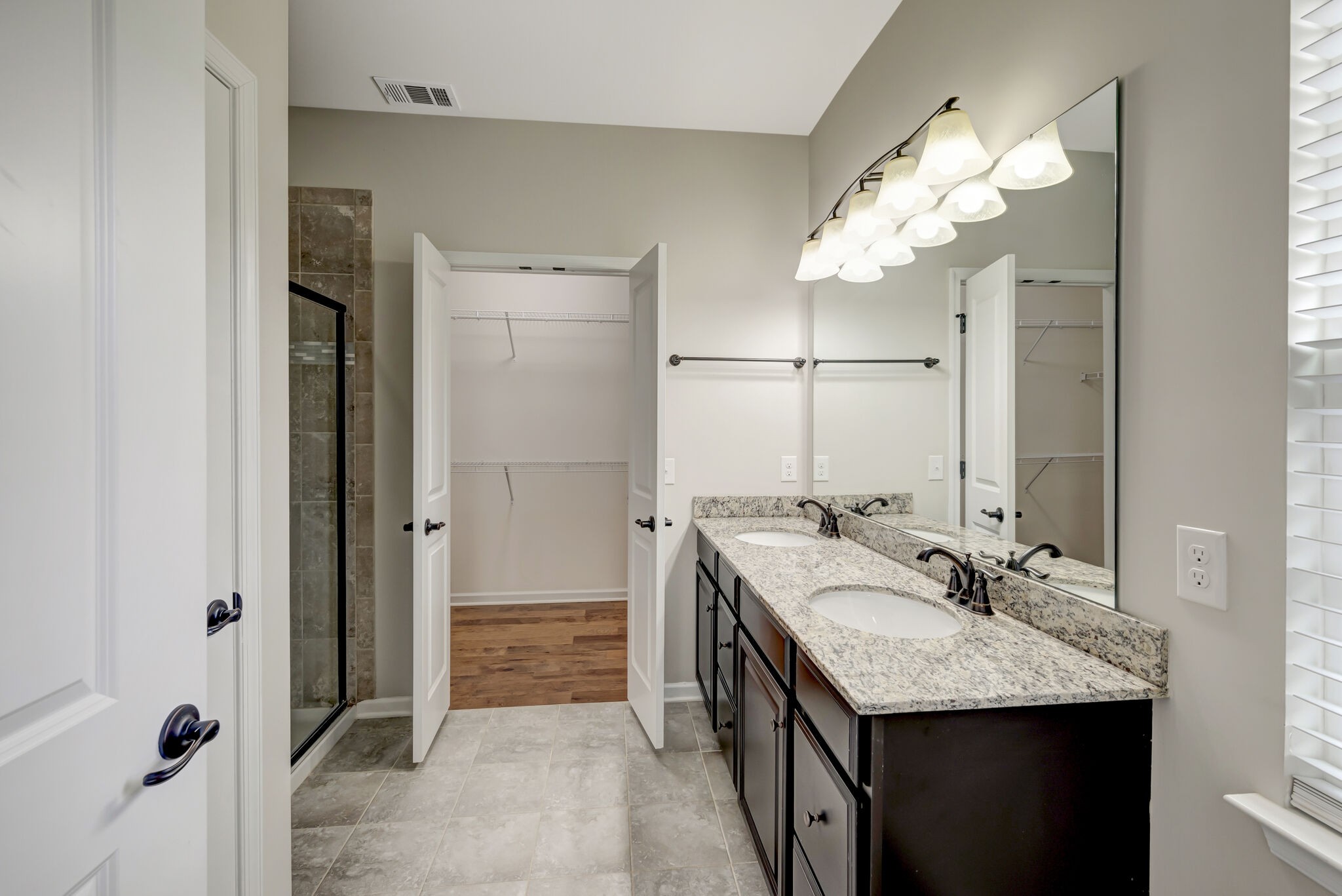 106 Shanache Drive Spring Hill, TN 37174 - Photo 11 of 31 a bathroom with a granite countertop sink a large mirror and a shower