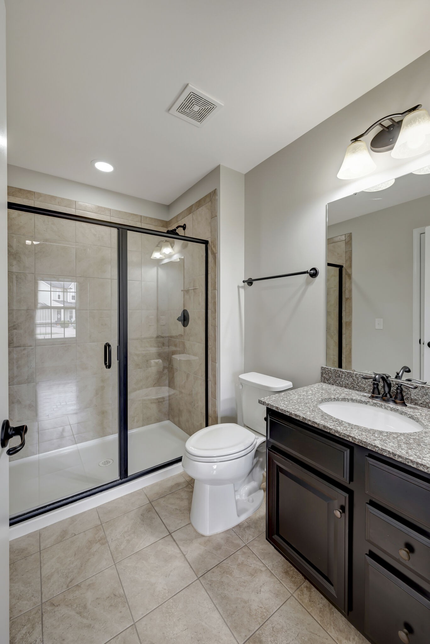 106 Shanache Drive Spring Hill, TN 37174 - Photo 16 of 31 a bathroom with a granite countertop sink a toilet a mirror and shower