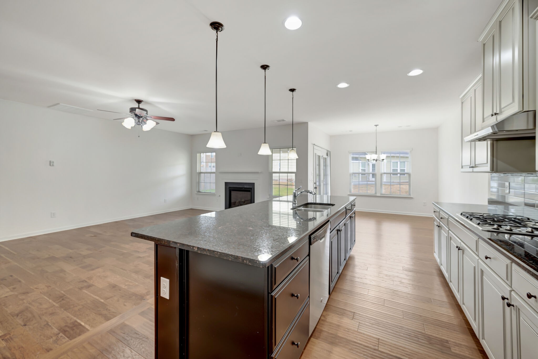 106 Shanache Drive Spring Hill, TN 37174 - Photo 7 of 31 a kitchen with kitchen island a stove a sink a center island and wooden floor
