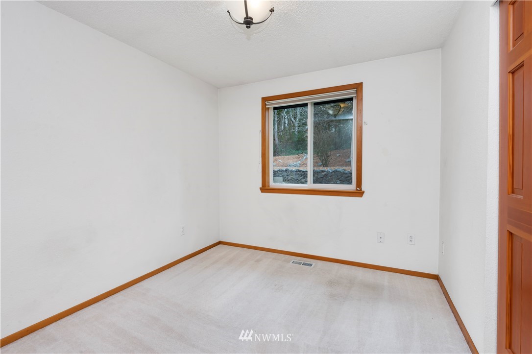 1900 Higgins Road Southeast Port Orchard, WA 98366 - Photo 14 of 26 a view of an empty room with a window