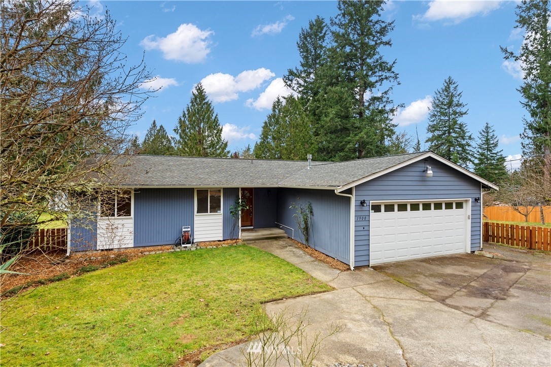 1900 Higgins Road Southeast Port Orchard, WA 98366 - Photo 2 of 26 a front view of a house with a yard and garage